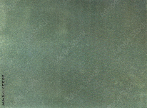 Green background. Velvet fleecy paper texture. Closeup