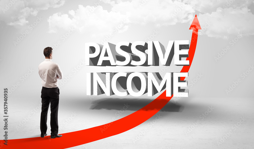 Rear view of a businessman standing in front of PASSIVE INCOME inscription, successful business concept Rear view of a businessman standing in front of PASSIVE INCOME inscription, successful business concept