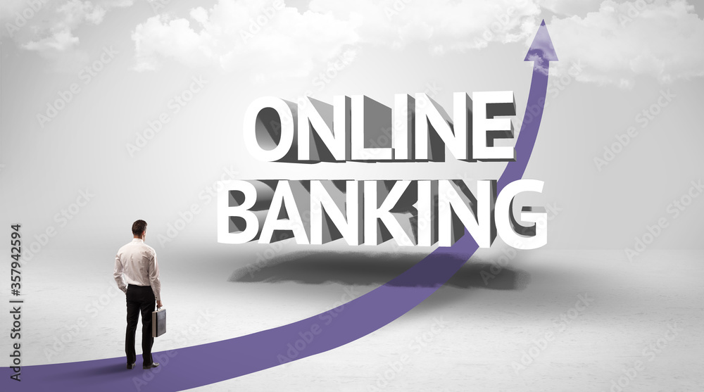 Rear view of a businessman standing in front of ONLINE BANKING inscription, successful business concept Rear view of a businessman standing in front of ONLINE BANKING inscription, successful business concept