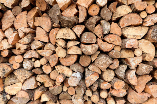 Large rural stack of firewood. Old firewood. Background.
