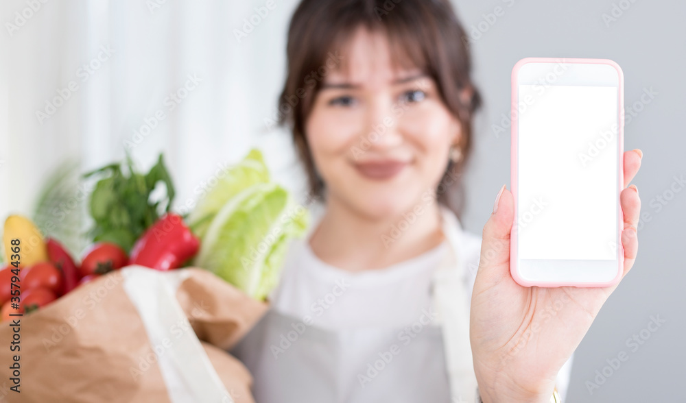 young woman showing screen with shopping bags young woman showing screen with shopping bags