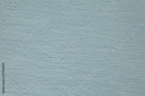 Texture of rough painted bluish tinted stucco.
