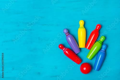 Cuadro en lienzo Wooden bowling toys on blue background. Kid game concept