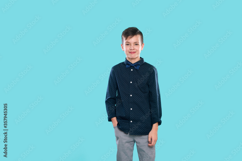 Happy, smiling boy on a blue background expresses emotions through gestures. Happy childhood concept Happy, smiling boy on a blue background expresses emotions through gestures. Happy childhood concept
