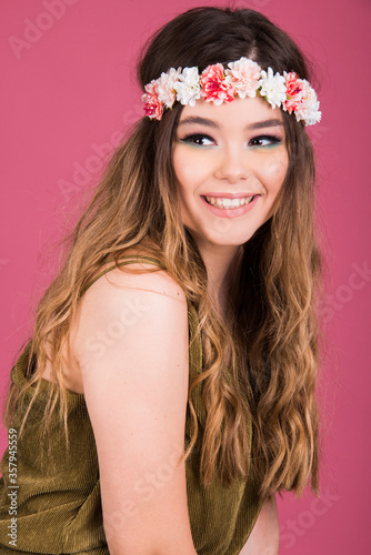 Portrait of young woman, beautiful teen model head shot with long hair and modern make up, stylish fashion look isolated on pink background, pastel color scheme style