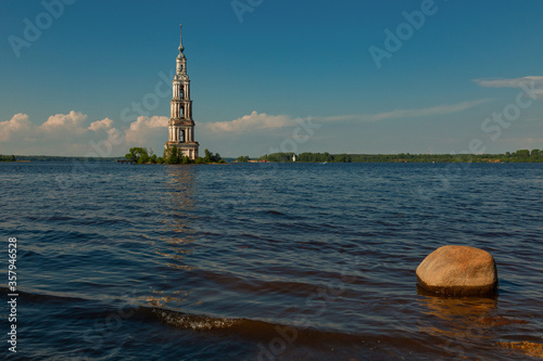 The flooded bell tower of an Orthodox church in the city of Kalyazin (Russia). In the foreground is a large boulder.
