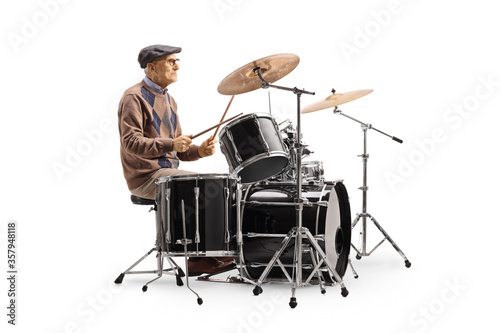 Elderly man playing a drum set