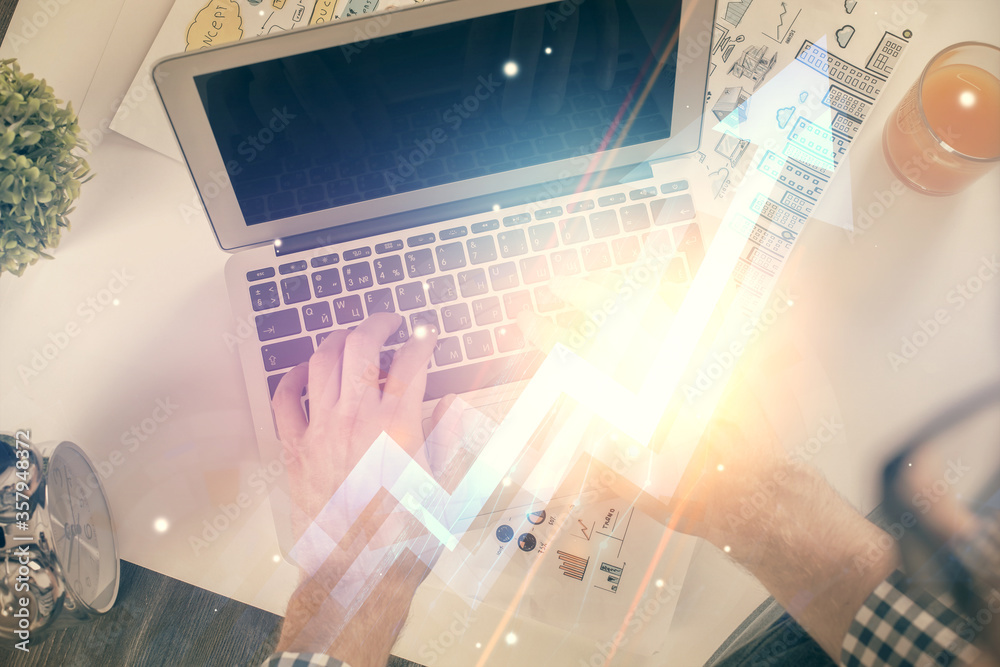 Double exposure of man's hands typing over computer keyboard and growing arrows hologram drawing. Top view. Success concept. Double exposure of man's hands typing over computer keyboard and growing arrows hologram drawing. Top view. Success concept.