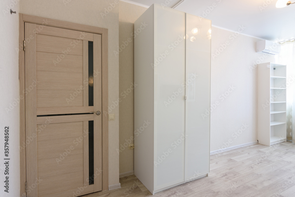 Fragment of the interior of the bedroom, entrance door and wardrobes Fragment of the interior of the bedroom, entrance door and wardrobes