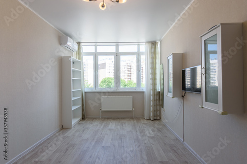 Partially empty room in the apartment with large windows