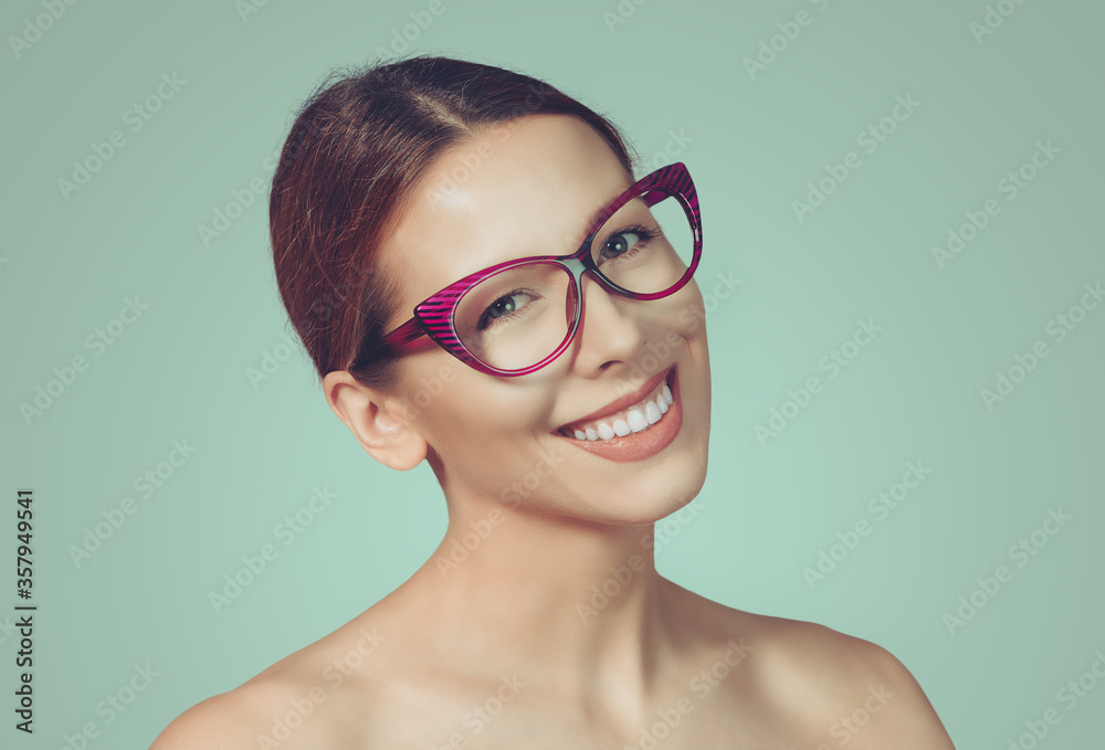 woman in glasses stands on a white background wall. Positive face expression. woman in glasses stands on a white background wall. Positive face expression.