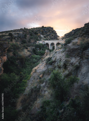 Beautiful and magical landscape of a magnificent bridge in the middle of nature with a magical sunset in Madrid