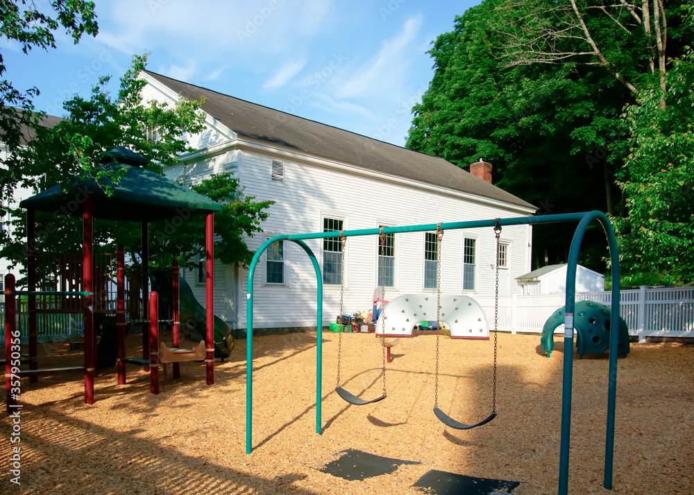 Bipod swing set and climbing house in backyard playground 