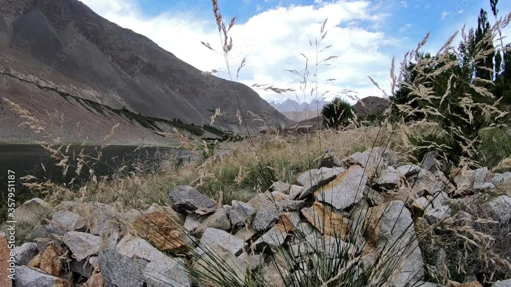 Revealing Shot Of a beautiful valley, mountians and lake in Borit, Hunza Valley, Gilgit Baltistan Pakistan Revealing Shot Of a beautiful valley, mountians and lake in Borit, Hunza Valley, Gilgit Baltistan Pakistan