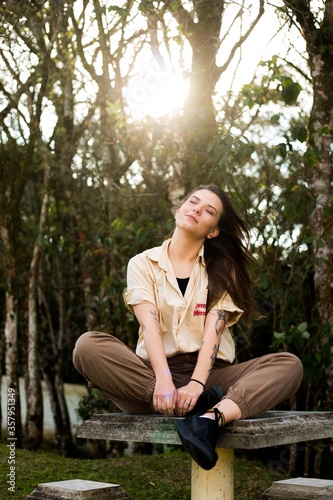 young woman sitting on a bench 