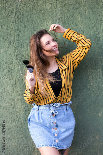 happy young woman on a green background