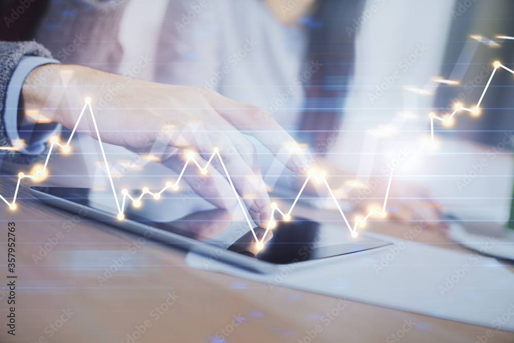 Naklejka premium Double exposure of forex graph drawing and man and woman working together holding and using a mobile device. Trade concept.