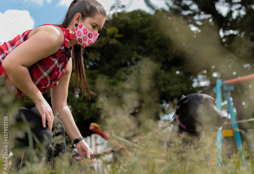 young woman playing with dog