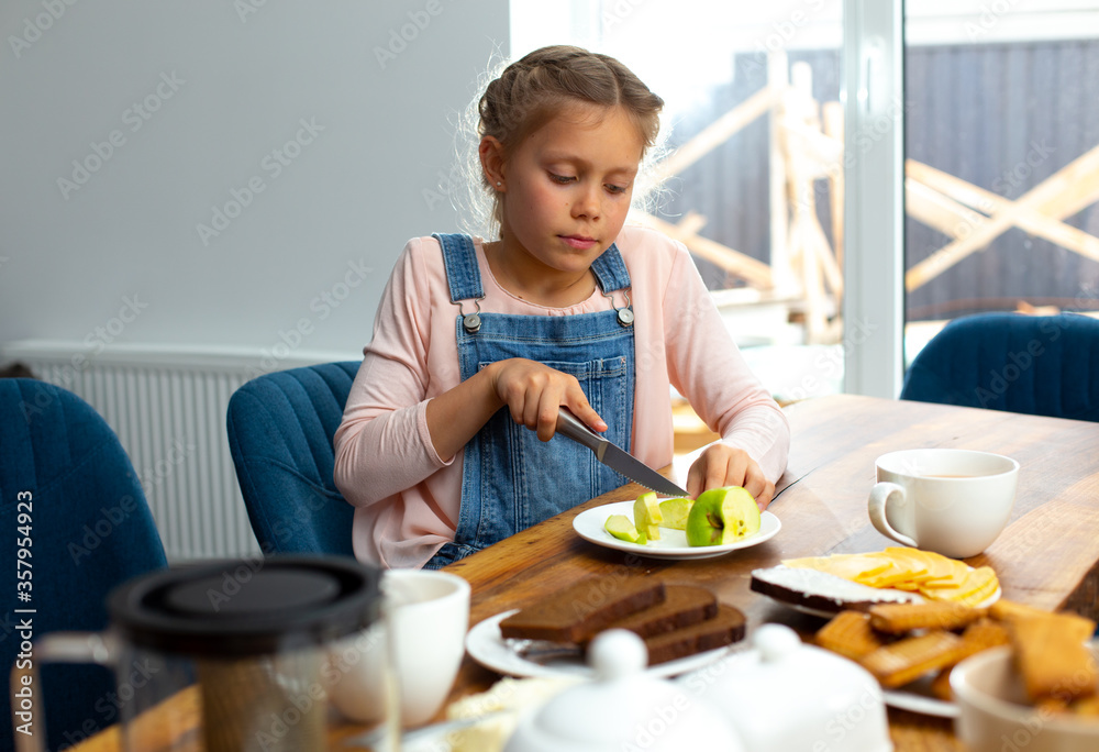 Cute little girl cutting apple with knife Cute little girl cutting apple with knife