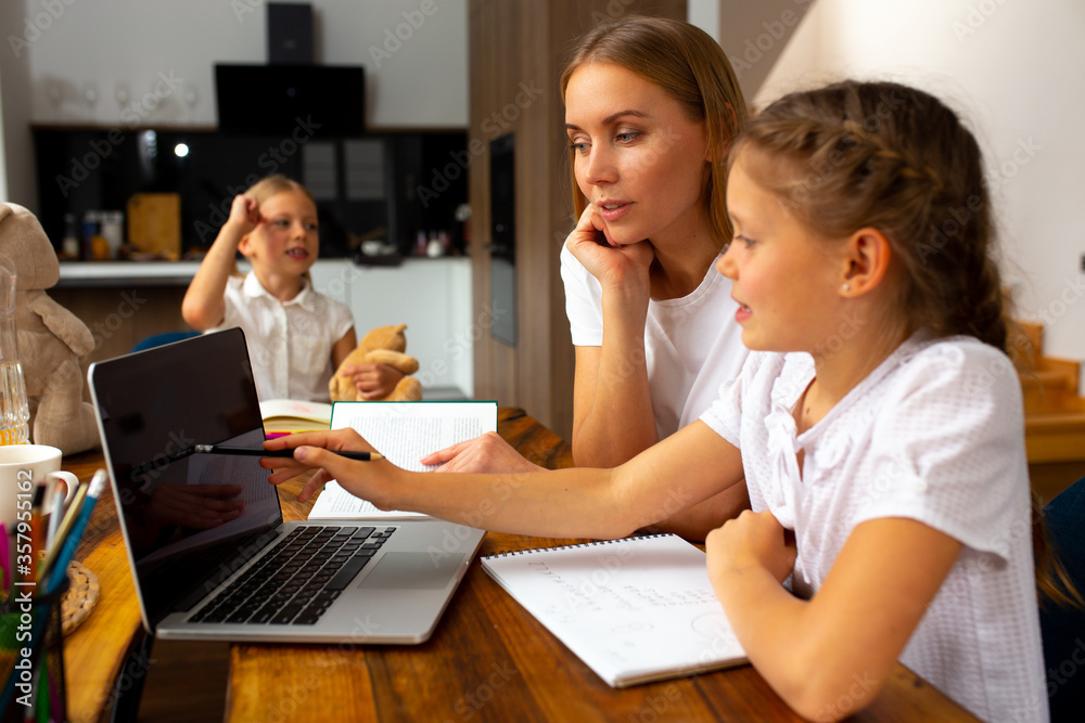 Charming mother and daughter studying at home Charming mother and daughter studying at home