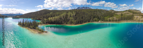 Stunning turquoise green lake in northern Canada, Yukon Territory. Emerald Lake located outside of Whitehorse in the Klondike. Wild and untouched. 