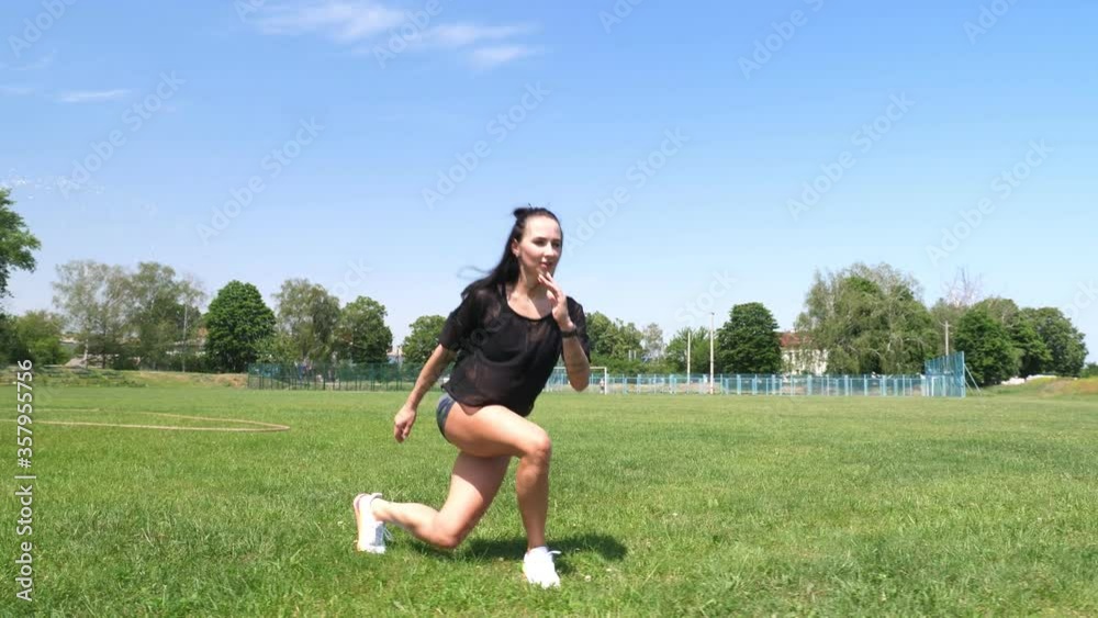 Fitness woman in sportswear doing various exercises on green grass of sports field, at stadium. Outdoor sports. online training. hot summer day. healthy lifestyle concept Fitness woman in sportswear doing various exercises on green grass of sports field, at stadium. Outdoor sports. online training. hot summer day. healthy lifestyle concept