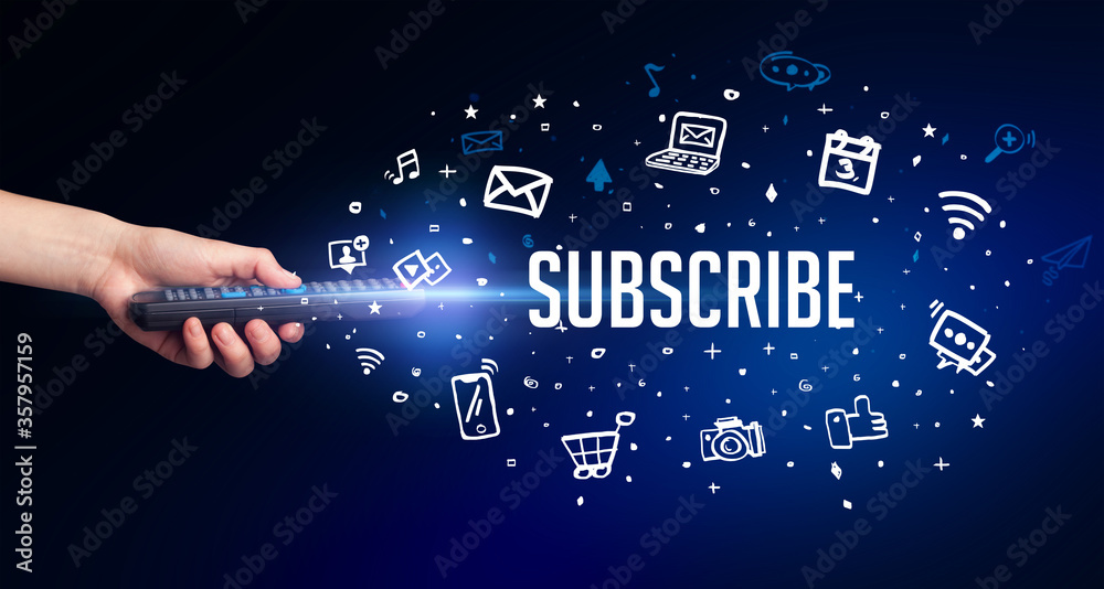 hand holding wireless peripheral with SUBSCRIBE inscription, social media concept hand holding wireless peripheral with SUBSCRIBE inscription, social media concept