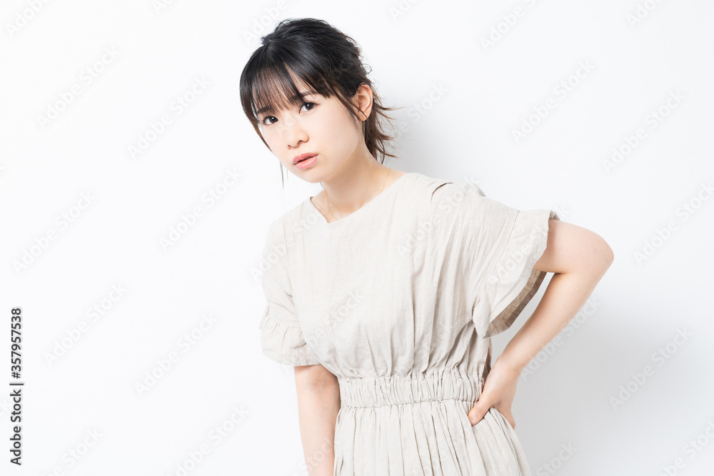 腰に手を当てる若い女性 腰に手を当てる若い女性
