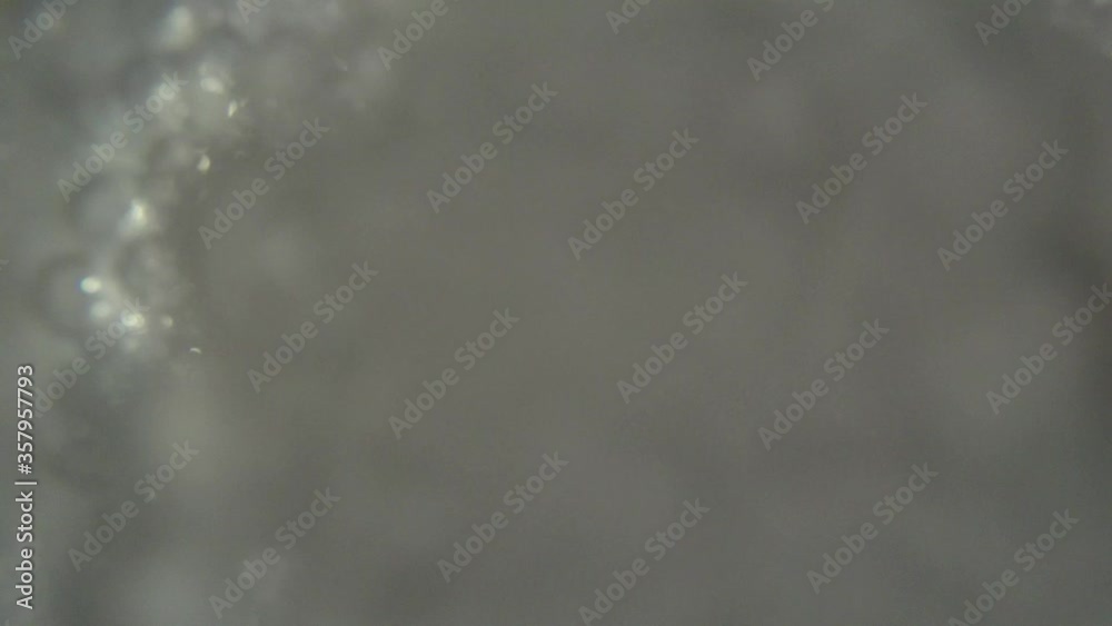 Filming inside plastic cup pouring clear soda water drink with bubbles young man puts on the lid with straw in 4k shot Filming inside plastic cup pouring clear soda water drink with bubbles young man puts on the lid with straw in 4k shot