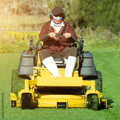 Gardener use Lawn mover on green grass