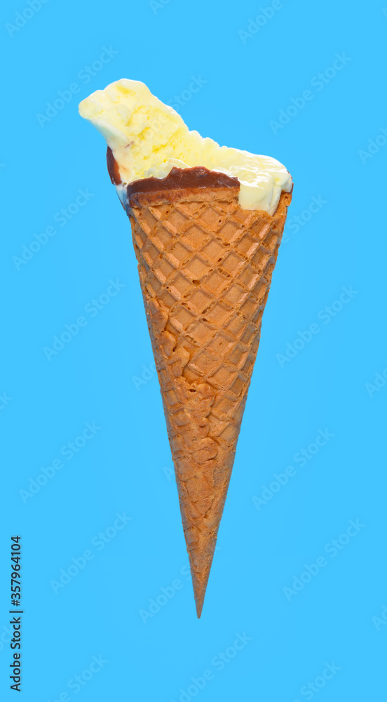 side view fresh pineapple ice cream cone with couple of bites on blue background side view fresh pineapple ice cream cone with couple of bites on blue background