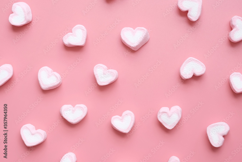 Sweet heart shape of pink marshmallows on pink paper background with copy space, decoration for love on valentine's day