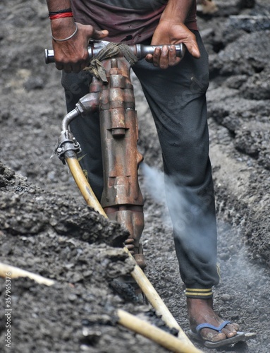 man doing road work with a heavy machine