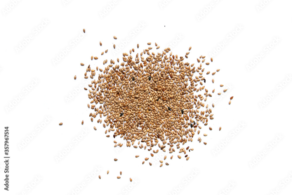 Heap of organic natural sesame seeds over isolated on white background Heap of organic natural sesame seeds over isolated on white background