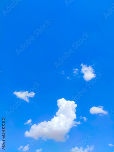 blue sky with single white clouds