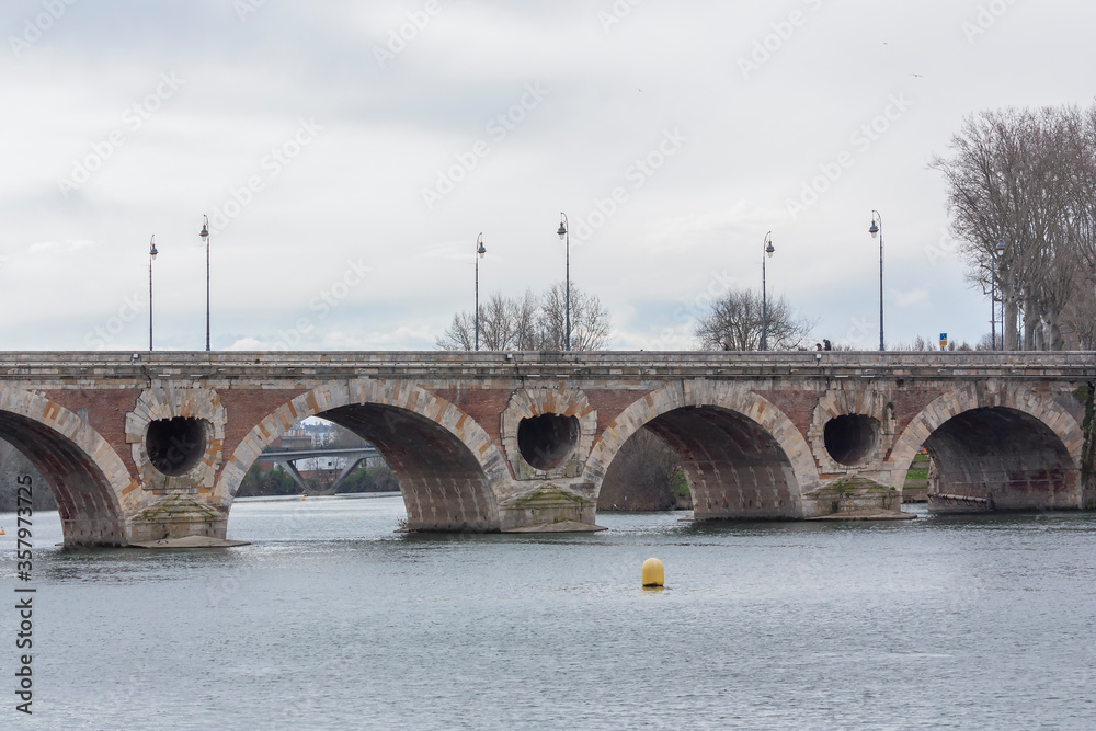 Ancient bridge over the river on a cloudy day