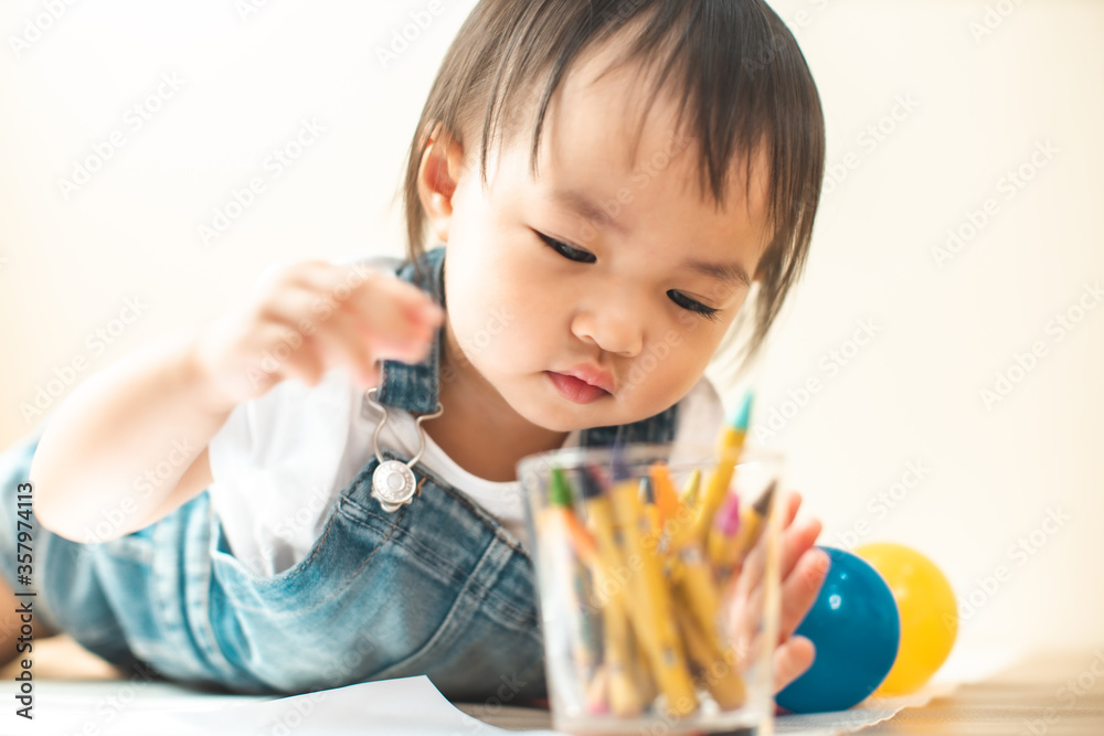 Cute asian little girl is painting the color with fully happiness moment , concept of art and education for kid. closed up kid practice paiting for homeschooling.Lovely asian girl drawing Cute asian little girl is painting the color with fully happiness moment , concept of art and education for kid. closed up kid practice paiting for homeschooling.Lovely asian girl drawing