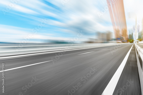 Fast moving asphalt road and bridge background.