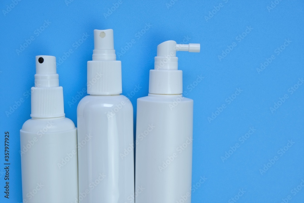 .Cosmetic bottles Mockup. White plastic bottles on a blue background. Beauty and health concept.Hand disinfector Bottle Set .Cosmetic bottles Mockup. White plastic bottles on a blue background. Beauty and health concept.Hand disinfector Bottle Set