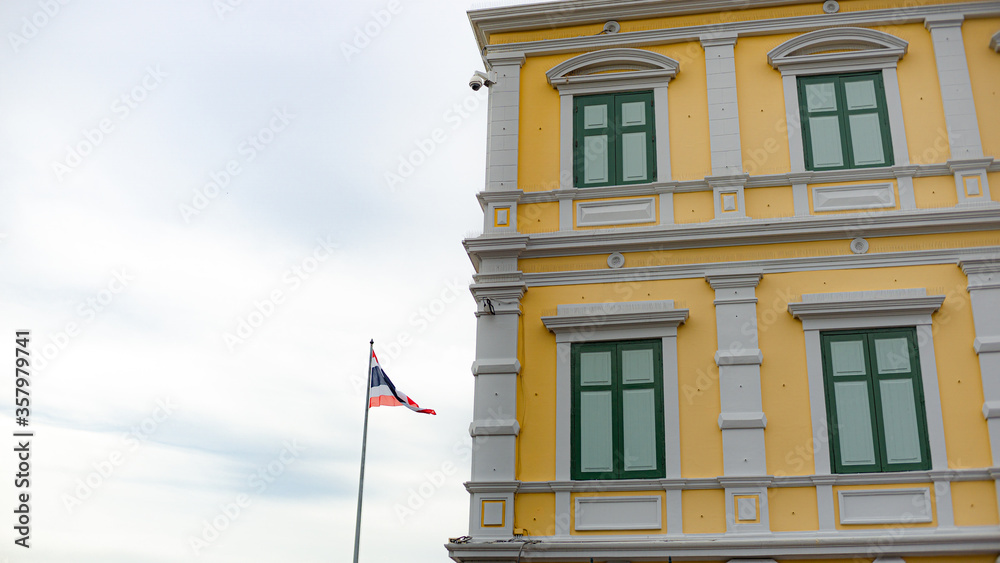 a Thai flag with historical building where located near to Royal Grand Palace