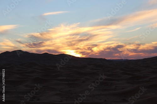 The sunset behind the large valleys in the desert
