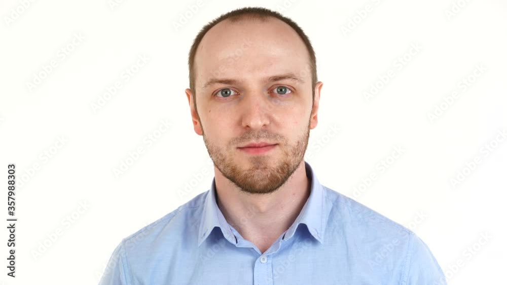 Handsome european man looking at camera. Portrait of guy in shirt over white background Handsome european man looking at camera. Portrait of guy in shirt over white background