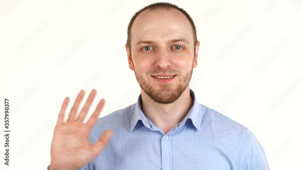 Handsome european man smiling at camera and waving his hand. Handsome european man smiling at camera and waving his hand.