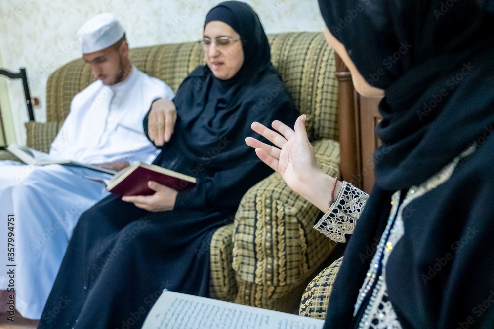 Happy muslim family reading books together and discussing ideas