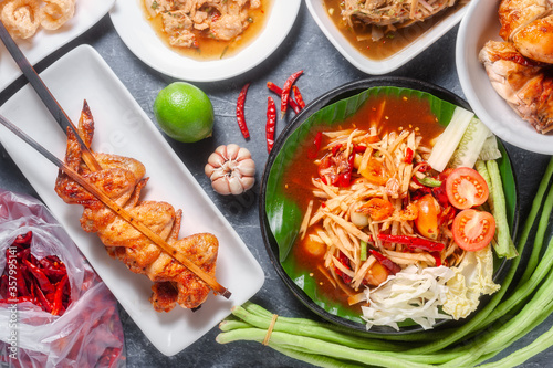 Green papaya salad with grilled chicken, slide grilled pork salad and spicy shredded bamboo shot salad. Thai northeast food.