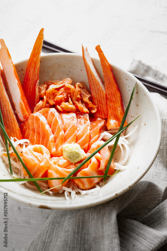 Salmon sashimi and imitation crab stick in Japanese style with kimchi, wasabi. Salmon sashimi and imitation crab stick in Japanese style with kimchi, wasabi.