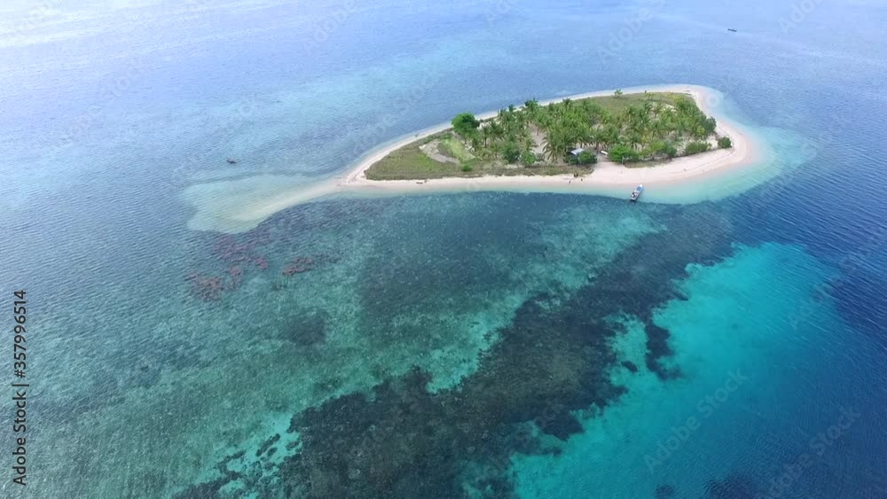 Truly amazing tropical island in the middle of the ocean. Aerial view of an island with white sand beaches and beautiful lagoons Truly amazing tropical island in the middle of the ocean. Aerial view of an island with white sand beaches and beautiful lagoons