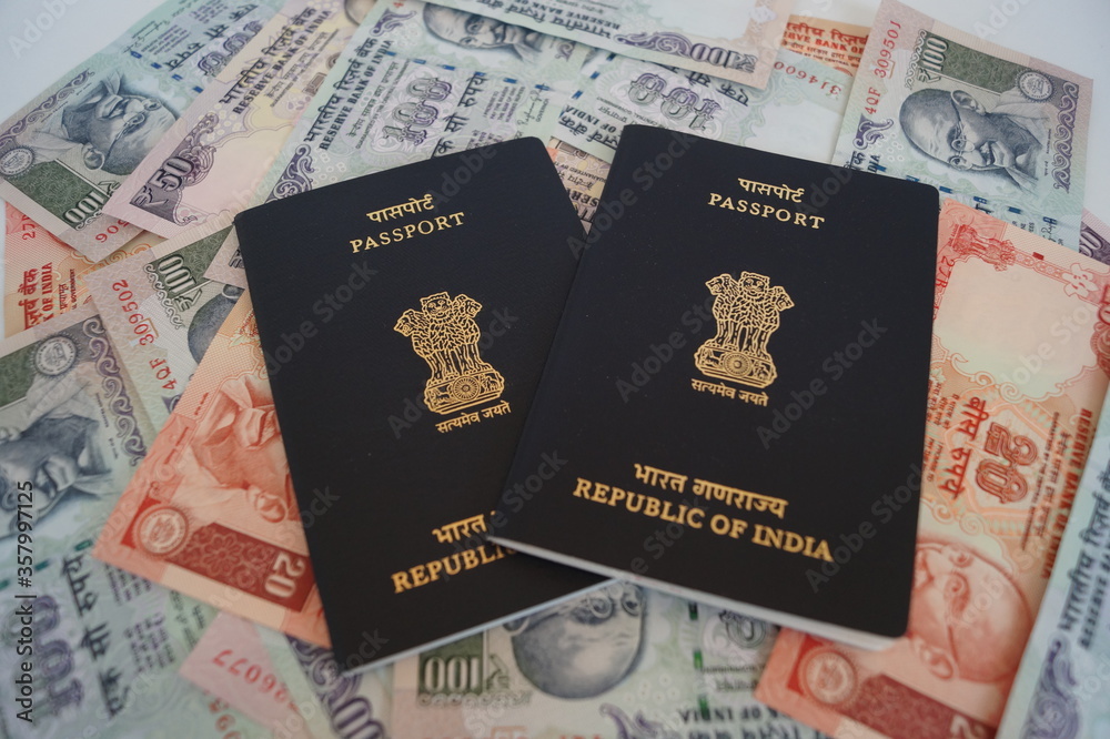 Indian passport with currency as background Indian passport with currency as background