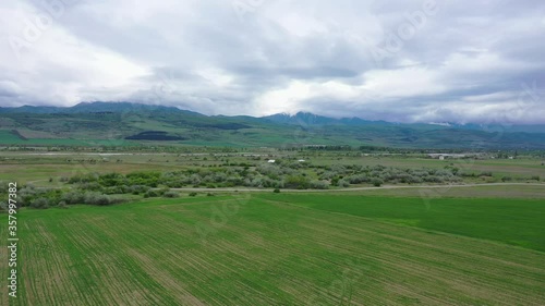 Wallpaper Mural Panoramic view of mountains covered with clouds. Cloudy weather in the mountains. Green spring fields. Aerial view Torontodigital.ca