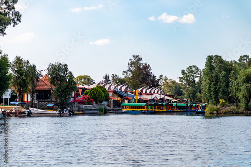 Panoramic view of Xochimilco channels or canals along the floating gardens or Chinampas in Mexico city at sunset